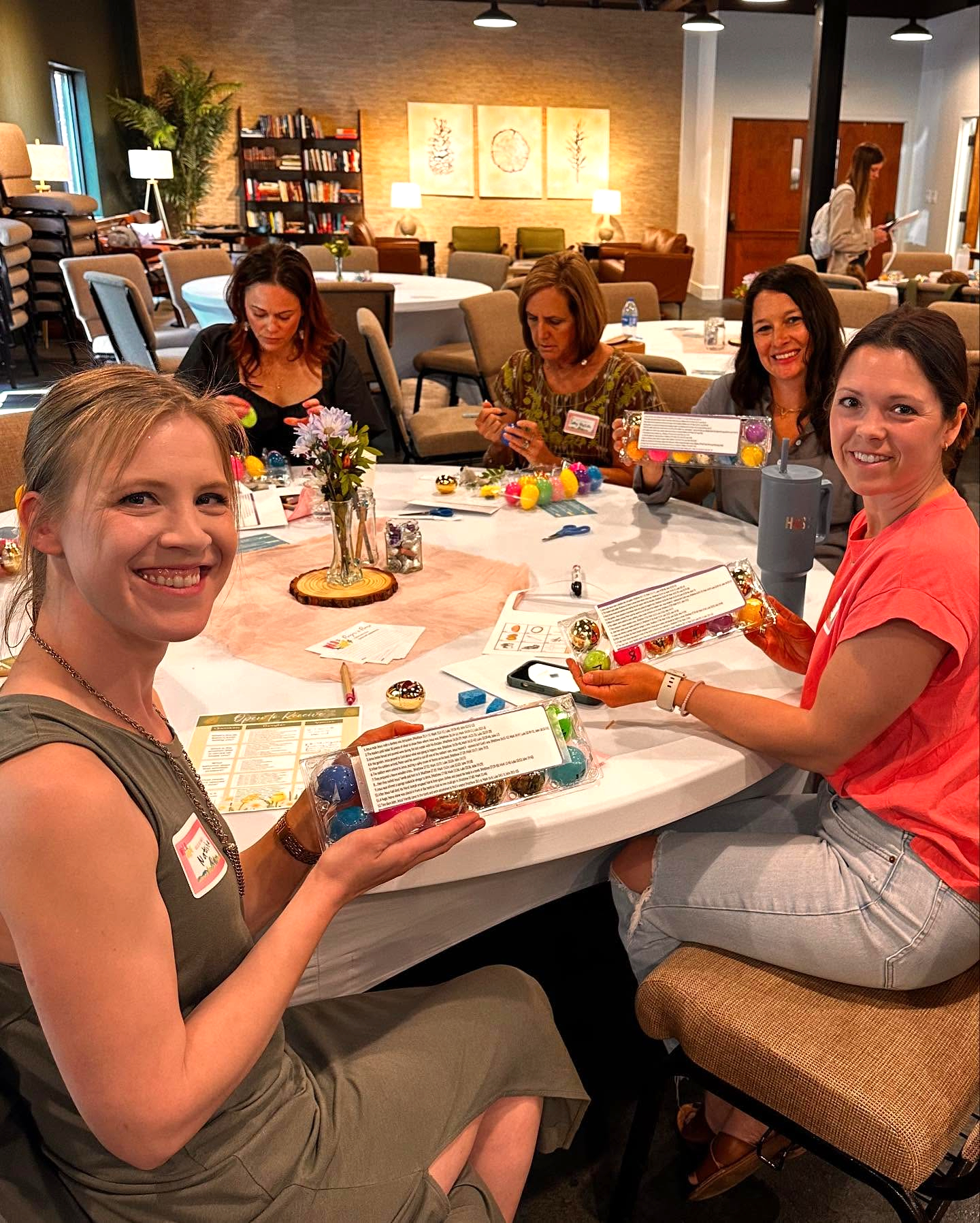 Moms gathered around a table at a MomCo South meetup